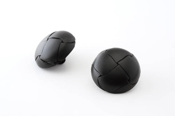 istock 2 pieces of black leather buttons on white background 691554452