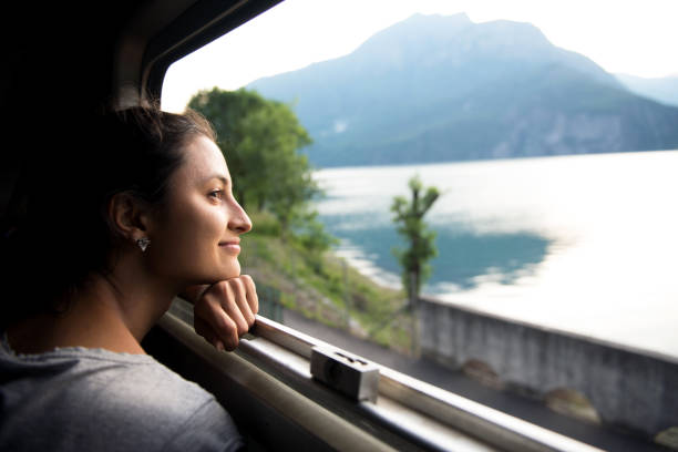 Smiling woman looking at the view from train
