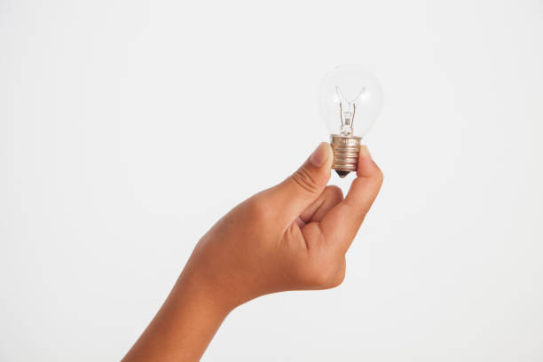 istock close up of hand holding light bulb,white background 691558206