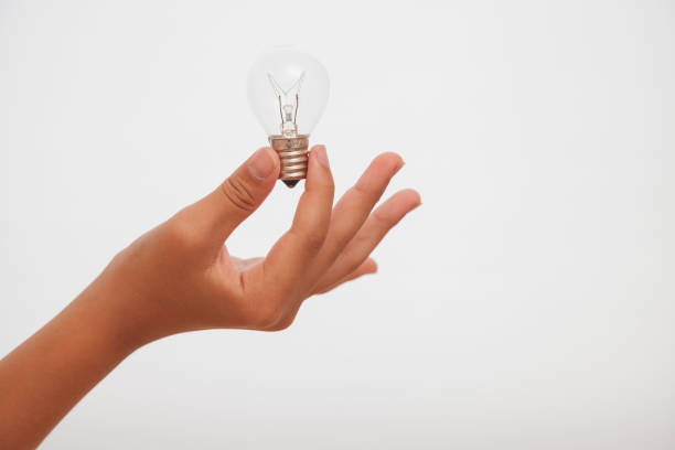 istock close up of hand holding light bulb,white background 691558208