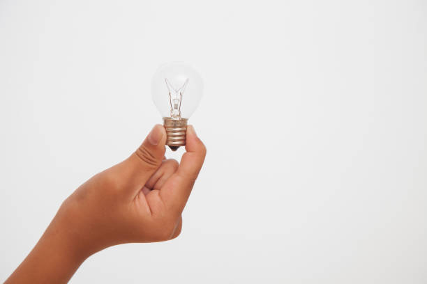istock close up of hand holding light bulb,white background 691558212