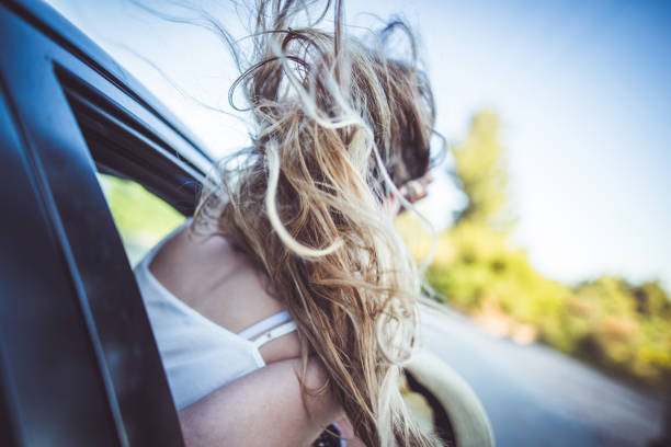 A young woman driving a car.