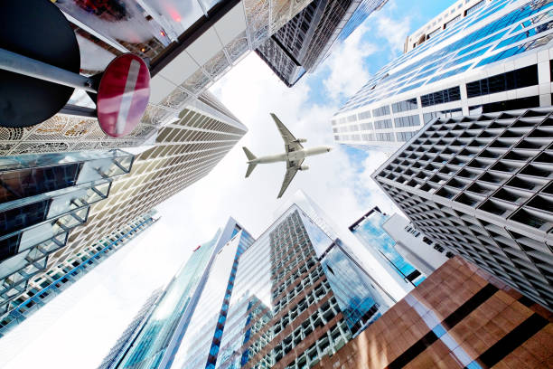 istock Airplane flying over business skyscrapers 691558546