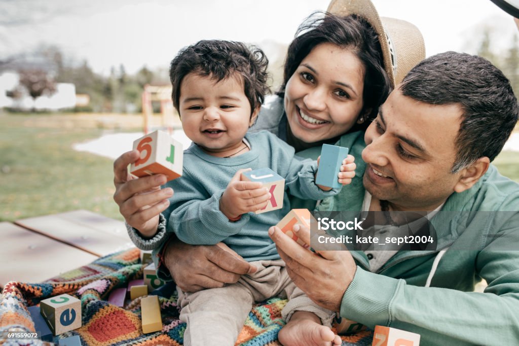 Happy parenting Smiling baby and happy parents Family Stock Photo