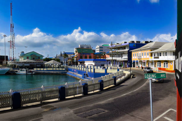 By the harbor. Georgetown, Cayman Islands - August 1, 2015: Road curves around the small harbor in the center of Georgetown on Grand Cayman Island. cayman islands stock pictures, royalty-free photos & images