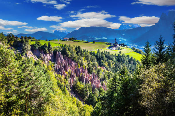 Renon's earth pillars at sunrise. Small mountain village in the Italian Tirol. Journey to the magic country. The concept of ecological tourism