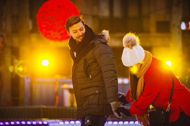 istock Young couple on a date at a public ice rink 691566808