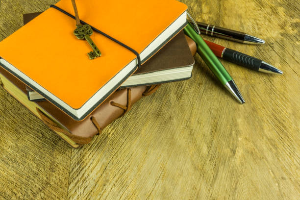 istock Notebooks with ballpoint pen on a wooden table 691569896