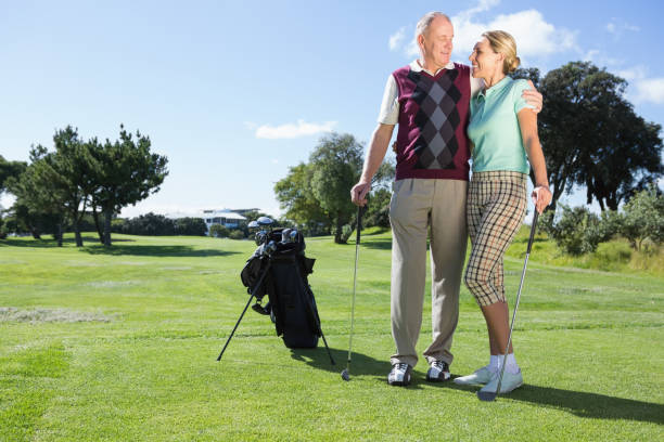 istock Golfing couple standing smiling at each other 691582478
