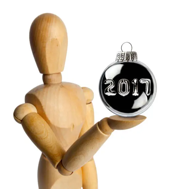 Photo of Wood Doll with a Christmas Baubles with 2017 Numbers Inside