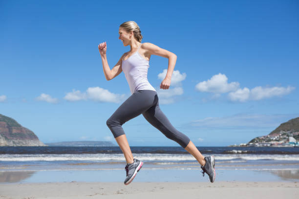 istock Pretty fit blonde jogging on the beach 691583126