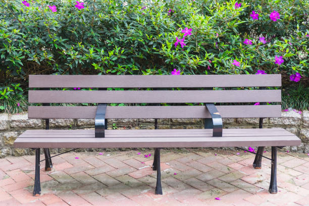 istock bench in park with flower background 691586348