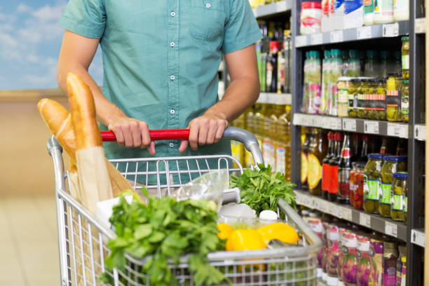 istock Man buy products with his trolley 691596308