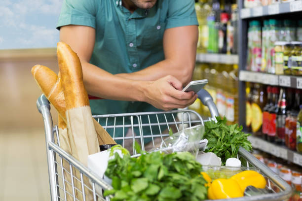 istock Man buy products and using his smartphone 691596340
