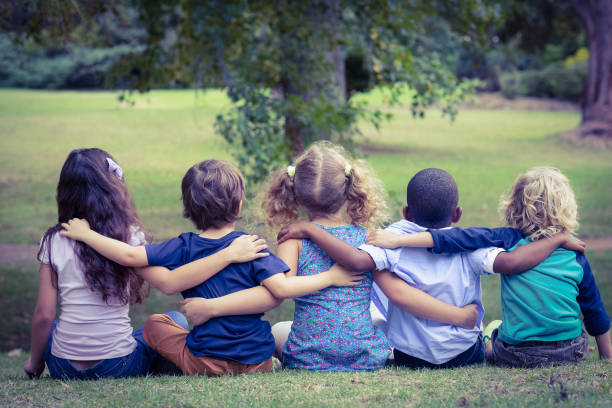 istock Back turned sitting children in the park 691609542