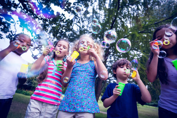 istock Children playing with bubble wand in the park 691609554