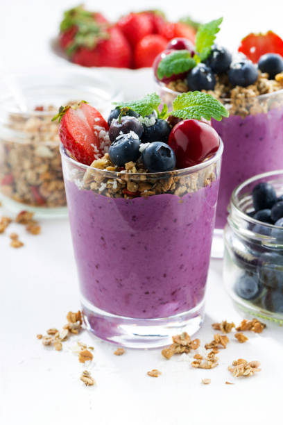 istock Blueberry dessert with granola on a white background, vertical 691609746