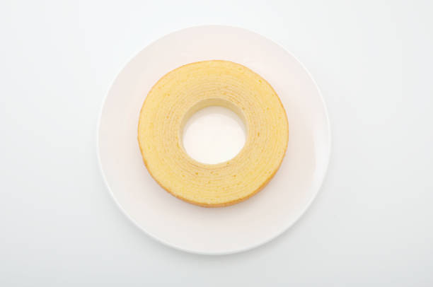 baumkuchen German doughnut cake on plate on white background