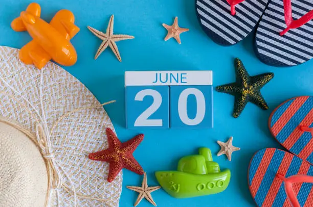 June 20th. Image of june 20 calendar on blue background with summer beach, traveler outfit and accessories. Summer day.
