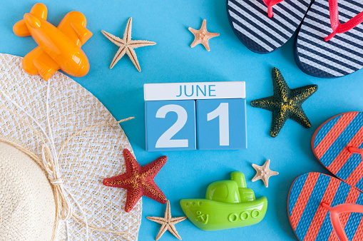 June 21st. Image of june 21 calendar on blue background with summer beach, traveler outfit and accessories. Summer day.