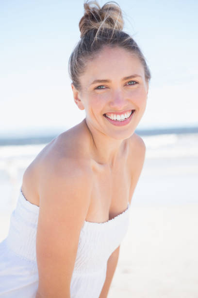 istock Pretty blonde on the beach smiling at camera 691609974