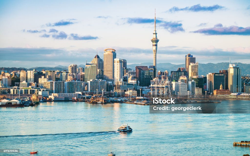 Auckland's skyline at dawn An early morning view of the CBD of Auckland, across the water of Waitemata Harbor. Auckland Stock Photo