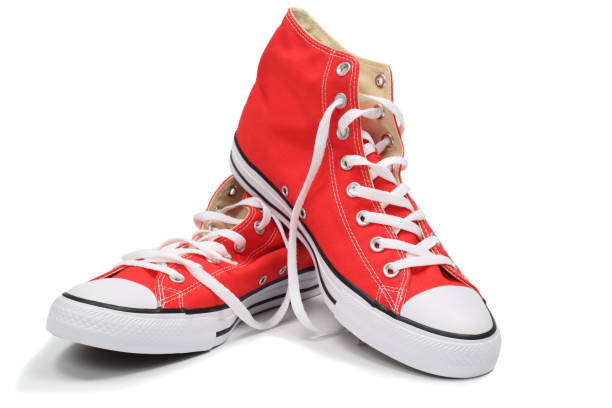 красные кроссовки - isolated on red стоковые фото и изображения