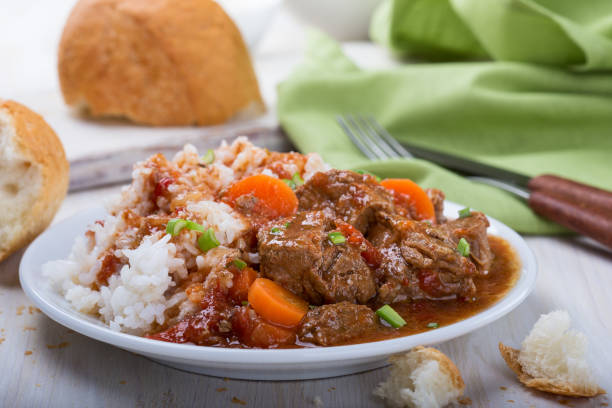 Beef and vegetable casserole Homemade beef and vegetable casserole served with rice on white plate, comfort food for a cold day beef stew stock pictures, royalty-free photos & images