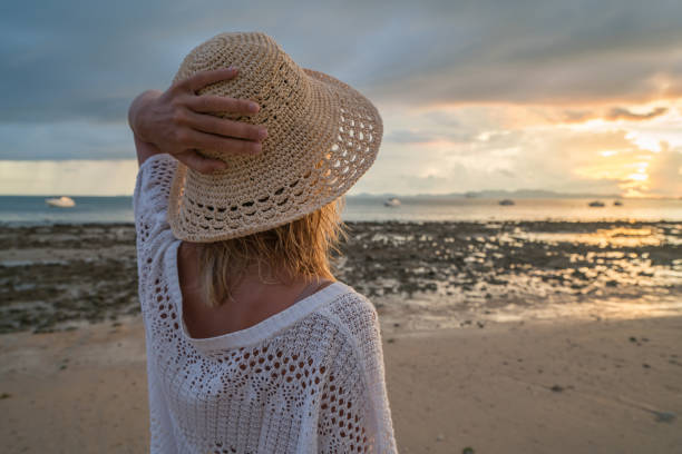 istock Beautiful girl on beach watching sunset 691617696