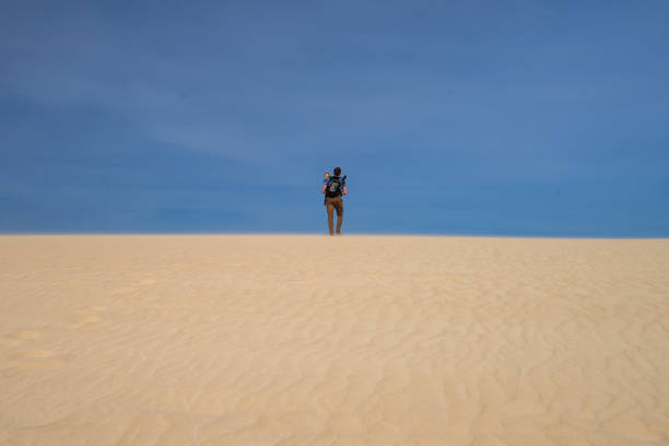 istock A man with the baby in the sand dunes 691619968