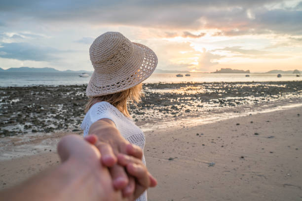 istock Come with me, woman leading man to beach 691620794