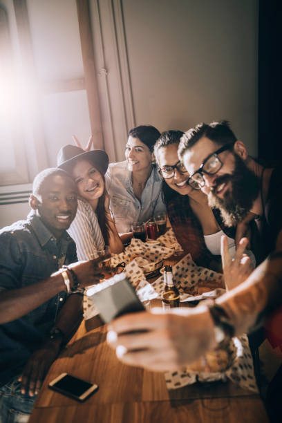 istock group of friends taking a selfie 691623764