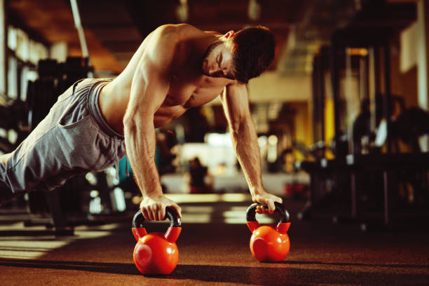 istock Handsome man doing pushups in the gym 691626996