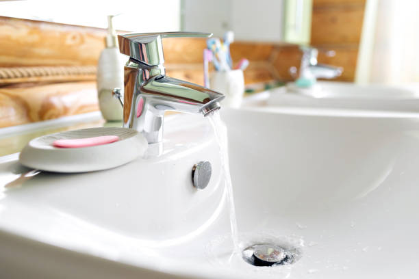 istock Working mixer tap in the bathroom closeup. water flows into the sink 691638200