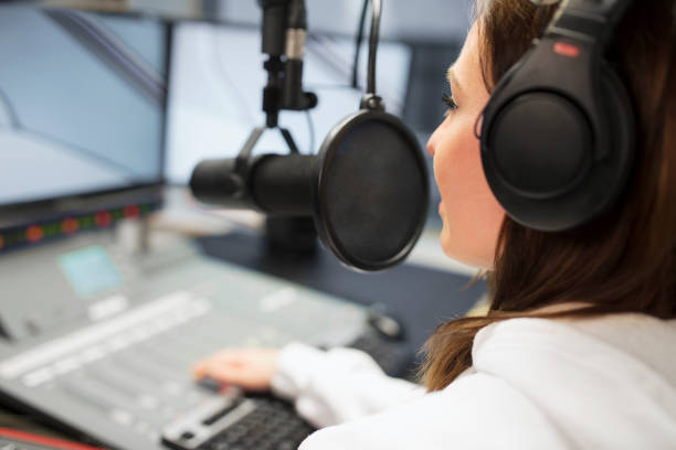 istock Jockey Wearing Headphones While Using Microphone In Radio Studio 691638696