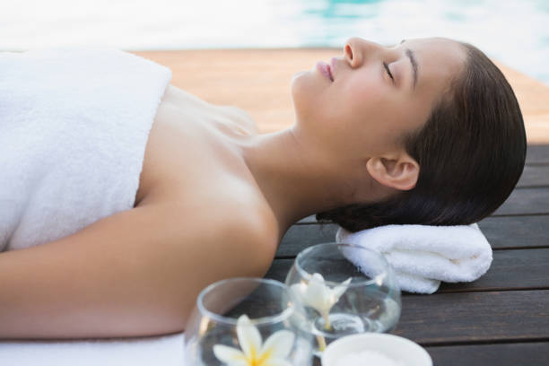 istock Peaceful brunette lying with eyes closed on a towel 691639066