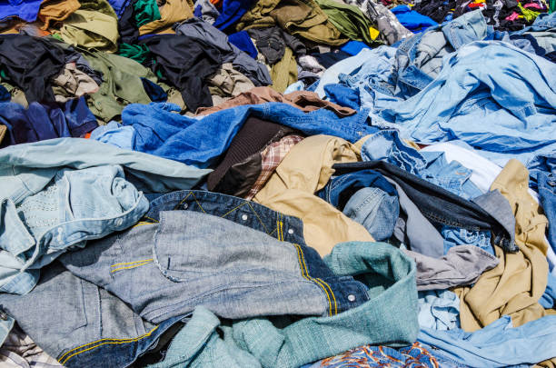 istock Heaps of clothing on the second hand market 691642176