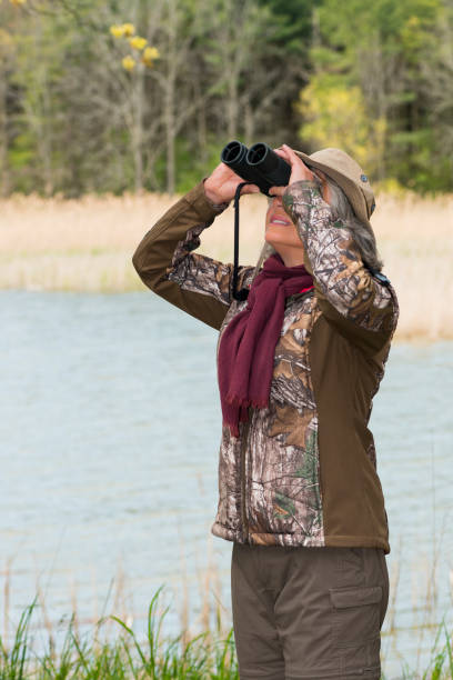 istock Woman birding, bird watching, active senior 691642684