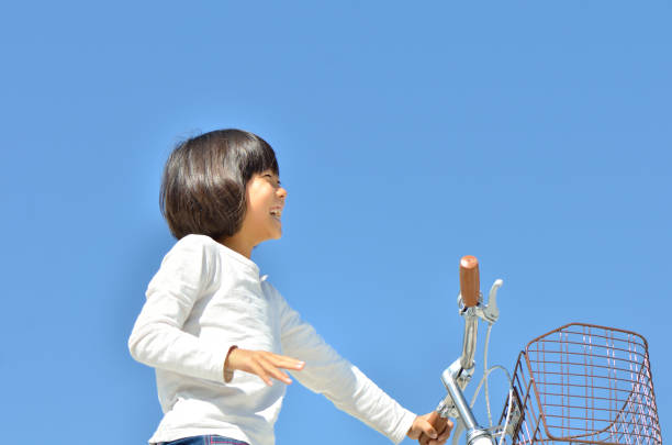 A girl on the bike A girl on the bike bicycle cycling school child stock pictures, royalty-free photos & images