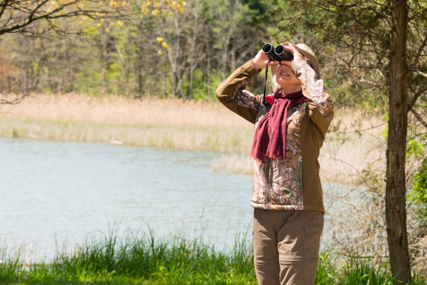 istock Woman birding, bird watching, active senior 691645190