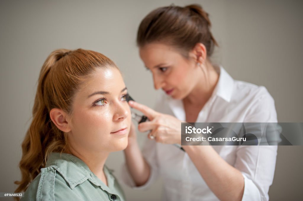 Dermatologist Inspecting Patient Face Skin with Dermatoscope Dermatologist Stock Photo