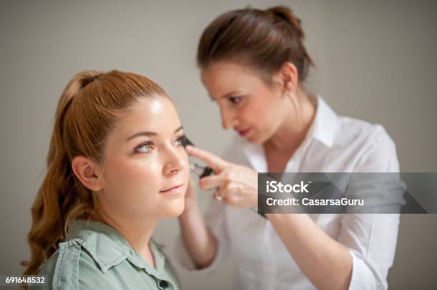 Dermatologist Inspecting Patient Face Skin With Dermatoscope Stock Photo - Download Image Now