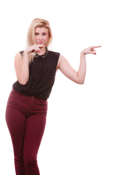 istock Blonde woman pointing with hands at copyspace 691649462