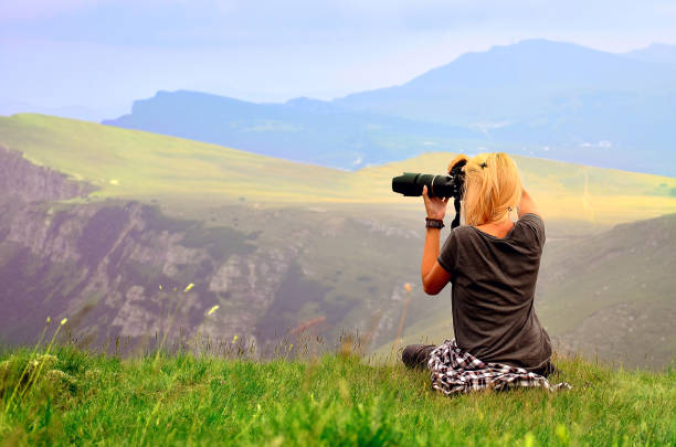 istock Woman photographing the sunset 691651332