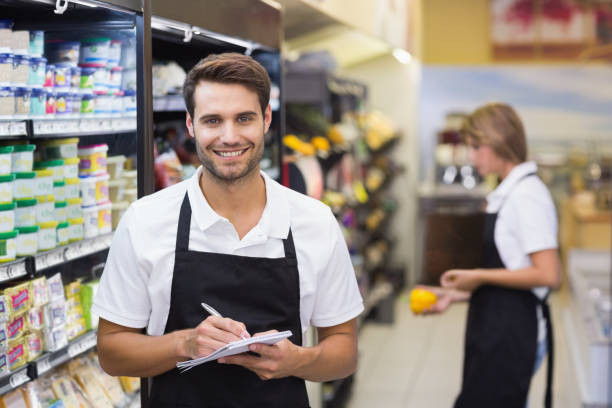 istock Portrait of smiling staff man writing on notepad 691652016