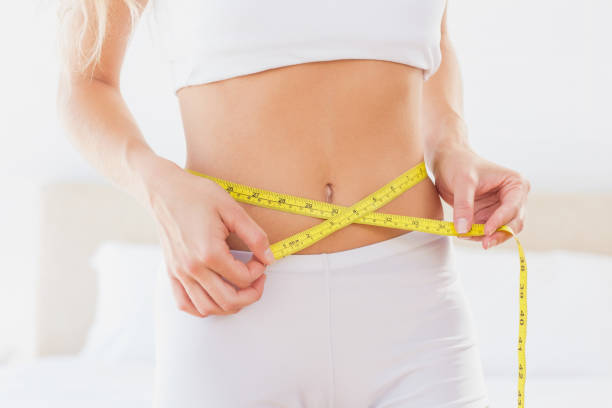 istock Slim woman measuring her waist 691652696