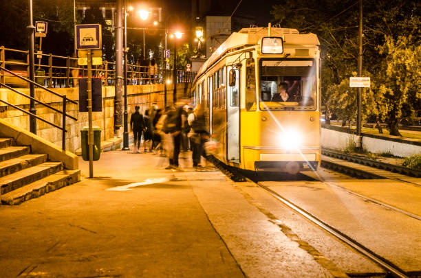 istock Long exposure of Budapest tramway at night with people 691662886