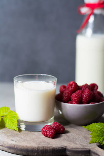 istock Fresh cow milk and ripe organic red raspberry 691662978