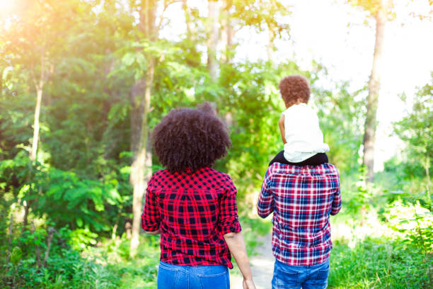 istock Happy family walking along a path in the woods 691666762