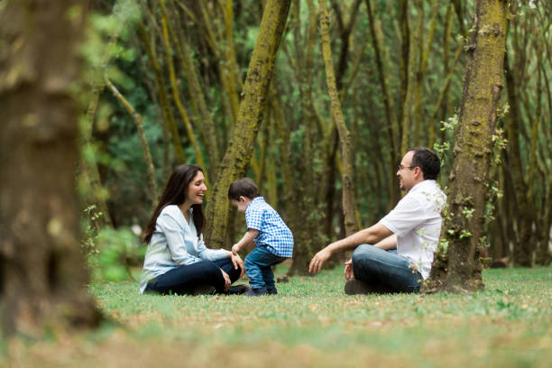 istock Fun parents playing with little boy outdoors 691669692